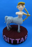 knitted toy of a centaur with a bow